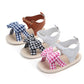 Pair of baby sandals with gingham bows in white, brown, and pink plaid accents