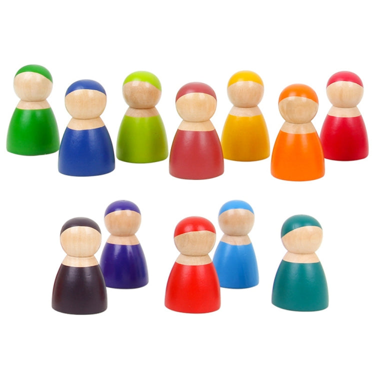 Twelve rainbow wooden peg dolls standing in a row, round heads and smooth bodies