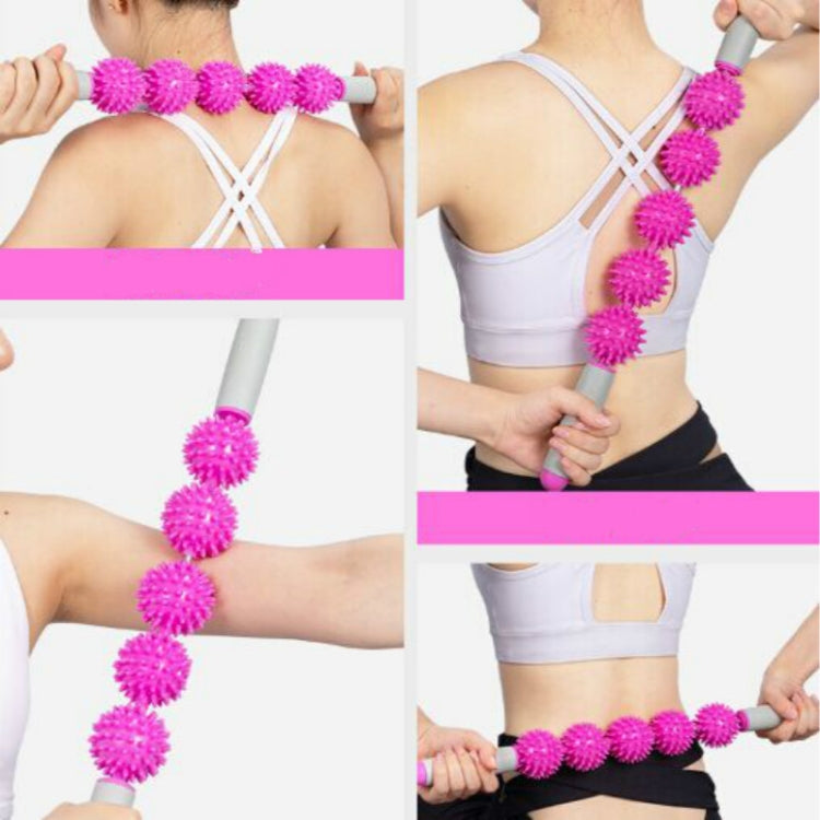 Pink hedgehog ball massage roller stick for upper back and shoulders, shown in use