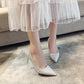 Women’s silver glitter stiletto pumps, pointed toe, sleek low-scoop silhouette