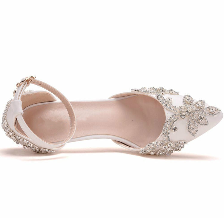 Side view of white rhinestone pointed-toe stiletto heels with ankle strap