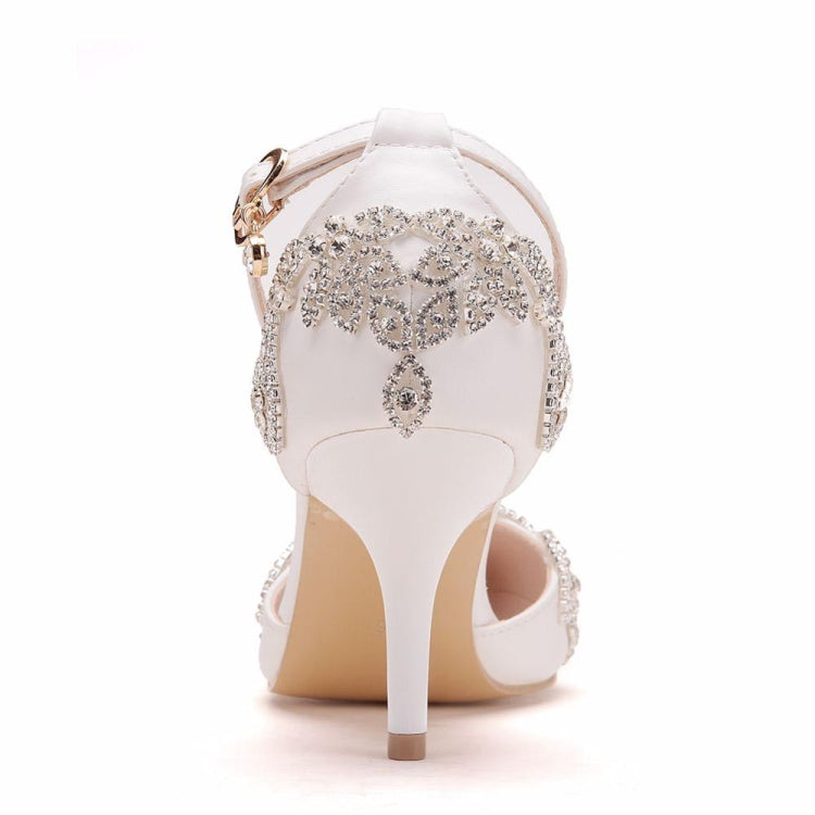 Rear view of white pointed-toe stiletto heels with rhinestone heel and ankle strap