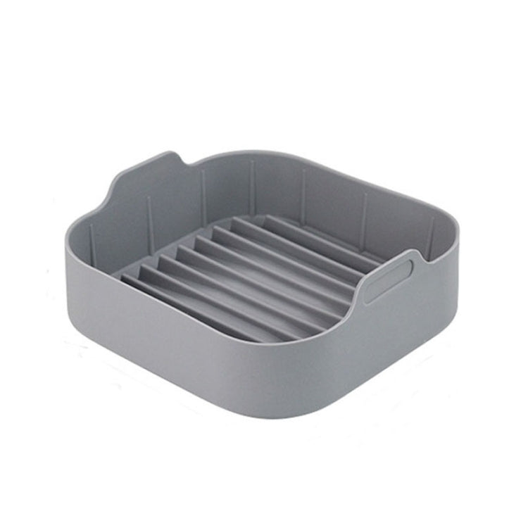 Gray square silicone grill pan insert with ridged lines and handle tabs