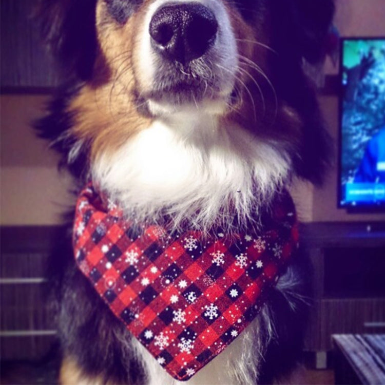 Pet close-up wearing red and black plaid triangle bandana towel with white snowflakes