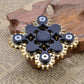 Black gear linkage fidget spinner with brass teeth and central round disc