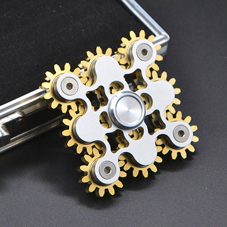 Silver gear linkage fidget spinner with gold brass teeth and rotating center disc