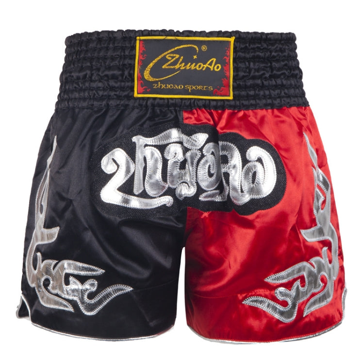 Muay Thai boxing shorts with black fabric and red side panel, silver logo and gold trim