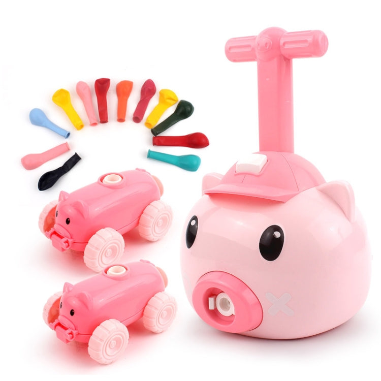 Pink pig balloon car toy with colorful accessory pieces and two small pig cars