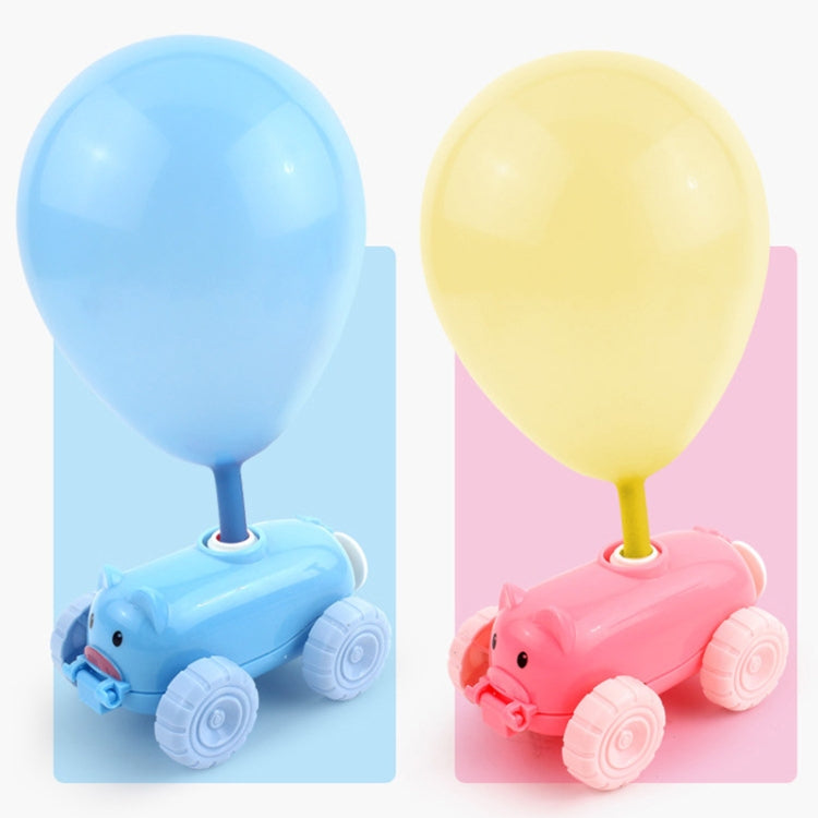 Close-up of blue and pink pig balloon cars with balloons and small friction cars
