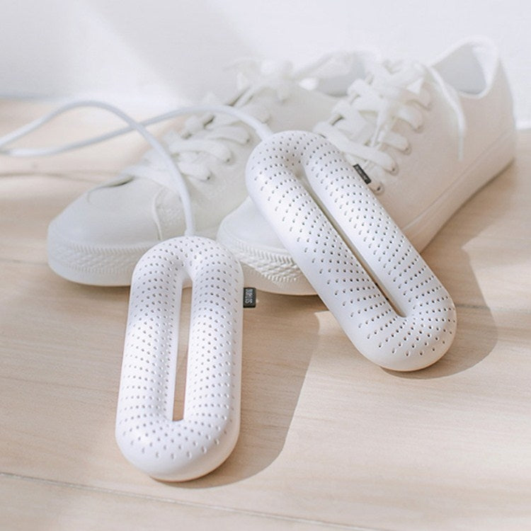 White shoe dryer inserts placed inside sneakers on a wooden floor
