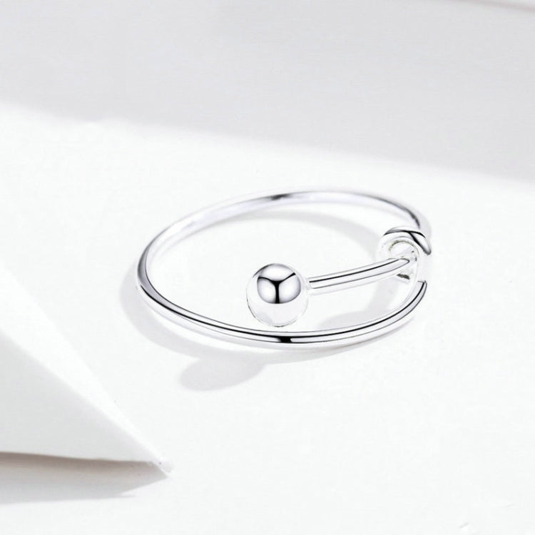 Silver open ring with a round bezel and hinged bar, shown from the side