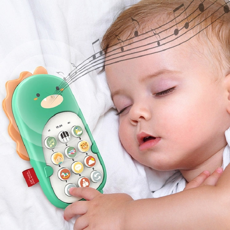Green dinosaur toy smartphone held by a baby on a soft blanket