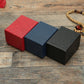 Set of textured jewelry boxes in red, blue, and black with hinged lids