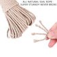 Natural beige hemp rope strand pulled apart by a hand, showing loose fibers