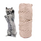 Cat standing upright beside a beige braided hemp rope scratch roll for claws
