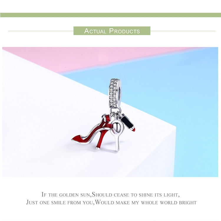 Sterling silver charm with red high-heel enamel and black accents, angled on a metal bail