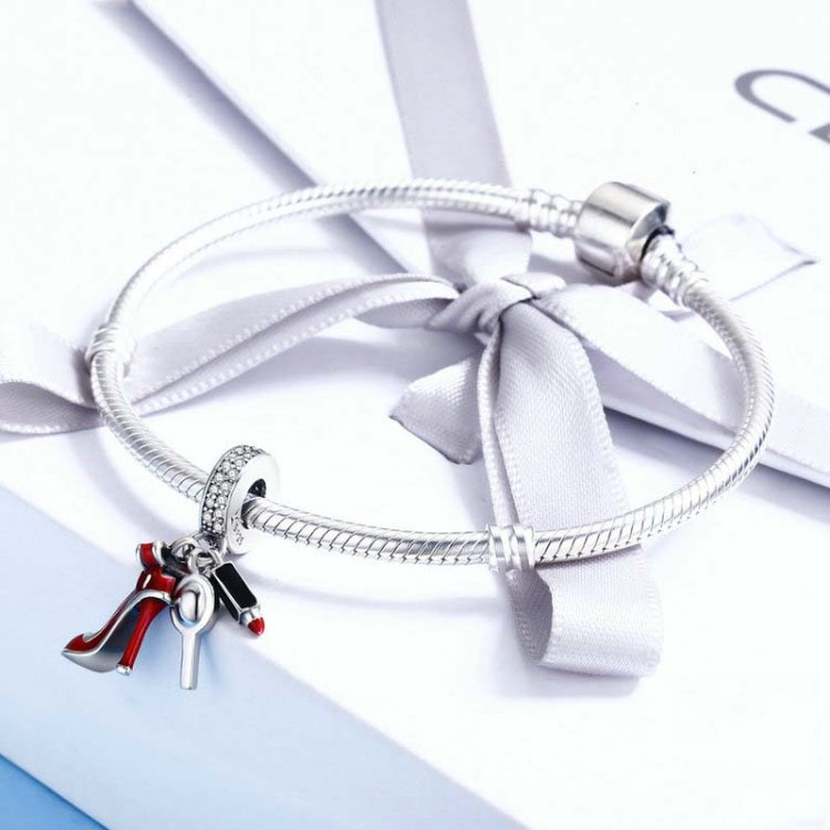 Sterling silver bracelet with white bow and red high-heel charm pendant