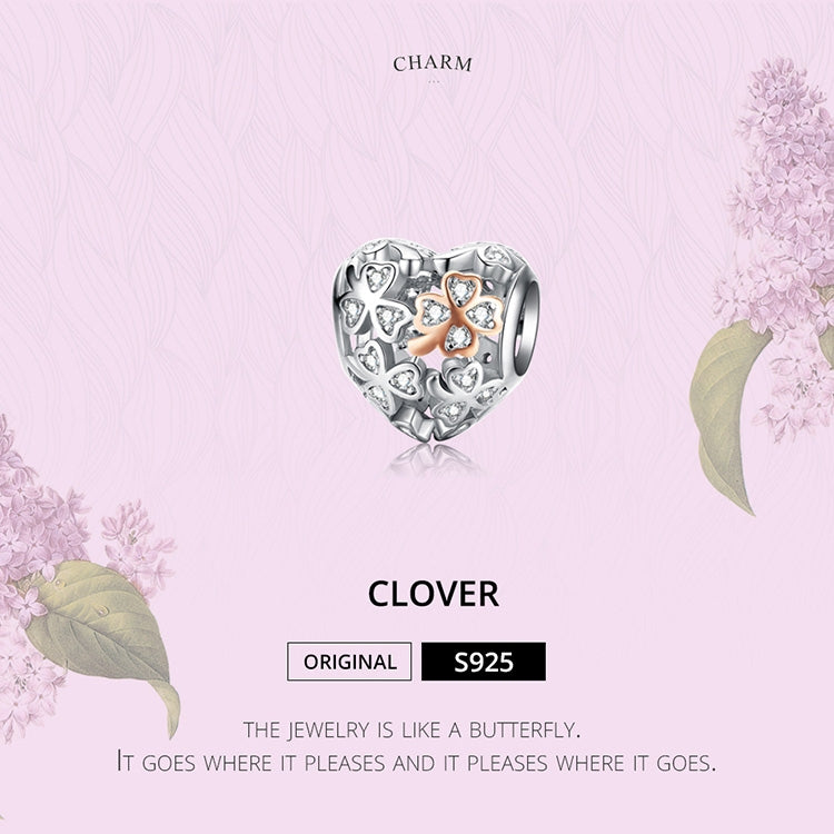 Heart-shaped charm bead with clover pattern, rose gold center, and sparkling CZ details.