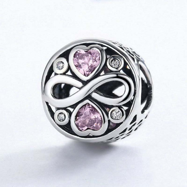 Sterling silver infinity design charm bead with pink heart crystals and round clear accents