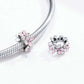 Pink enamel flower charm bead on a silver snake bracelet with ridged texture