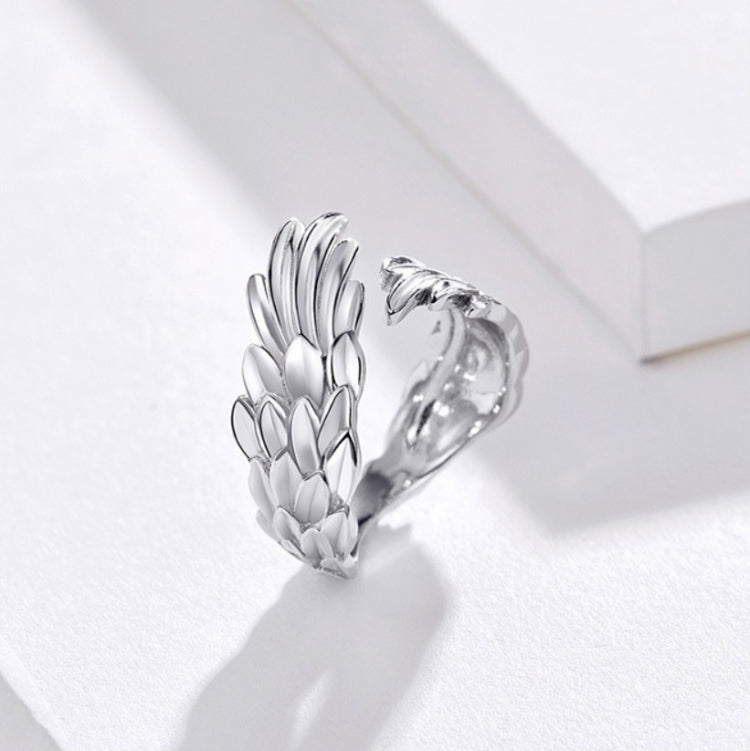 Sterling silver open feather-wing ring with adjustable band and textured feather detail