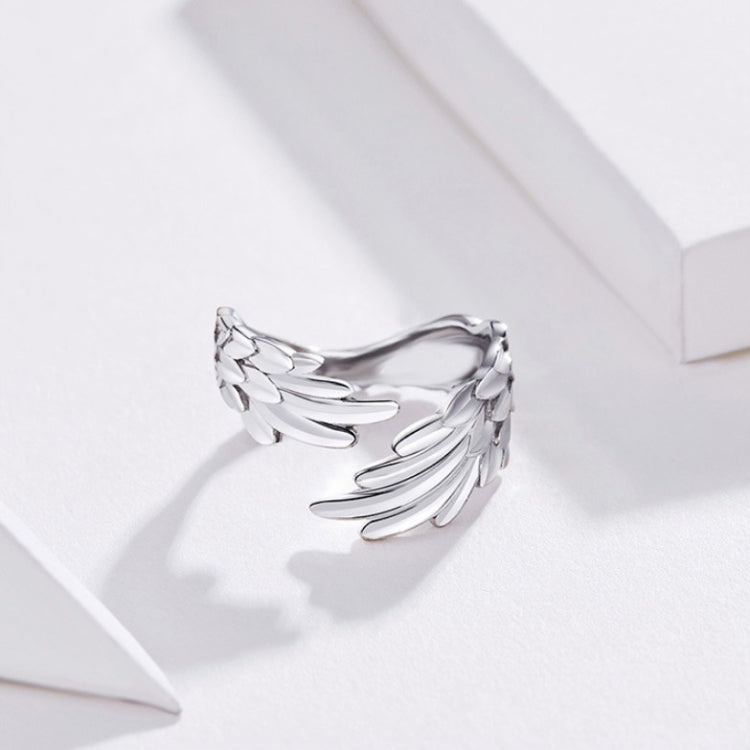 Sterling silver feather-wing open ring with layered wing feathers and adjustable band