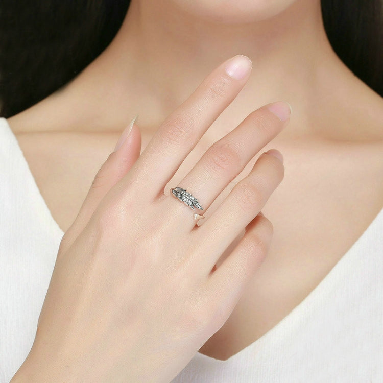 Silver open leaf ring on a woman's hand