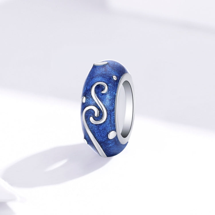 Blue star-glow enamel bead charm with silver swirl S pattern, side view