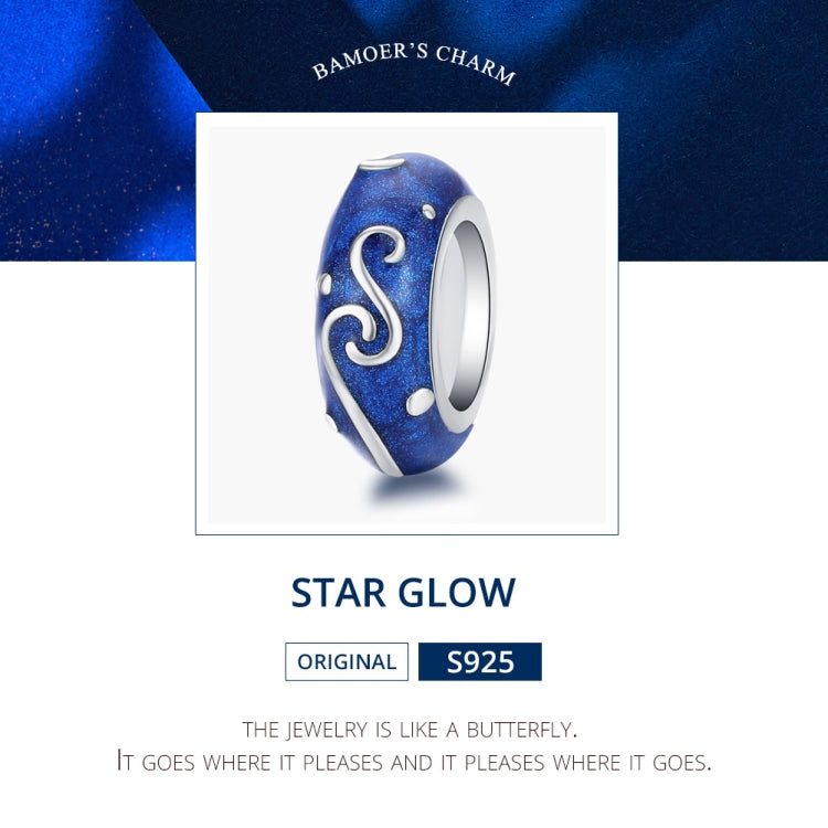 Blue star-glow enamel bead charm with silver swirl S and white dot accents, front view