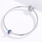 Silver charm bracelet with a blue star-glow enamel bead on a snake chain