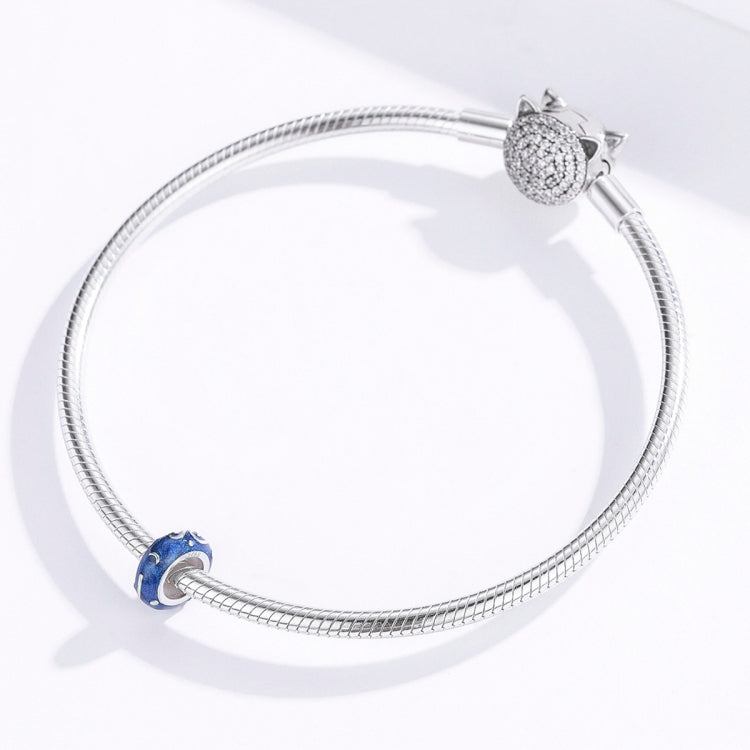 Silver charm bracelet with a blue star-glow enamel bead on a snake chain