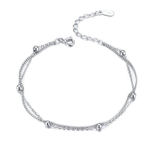 Silver bracelet with delicate chain links and small round charm details, lobster clasp.