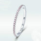 Sterling silver ring angled view with pink CZ stones along the band