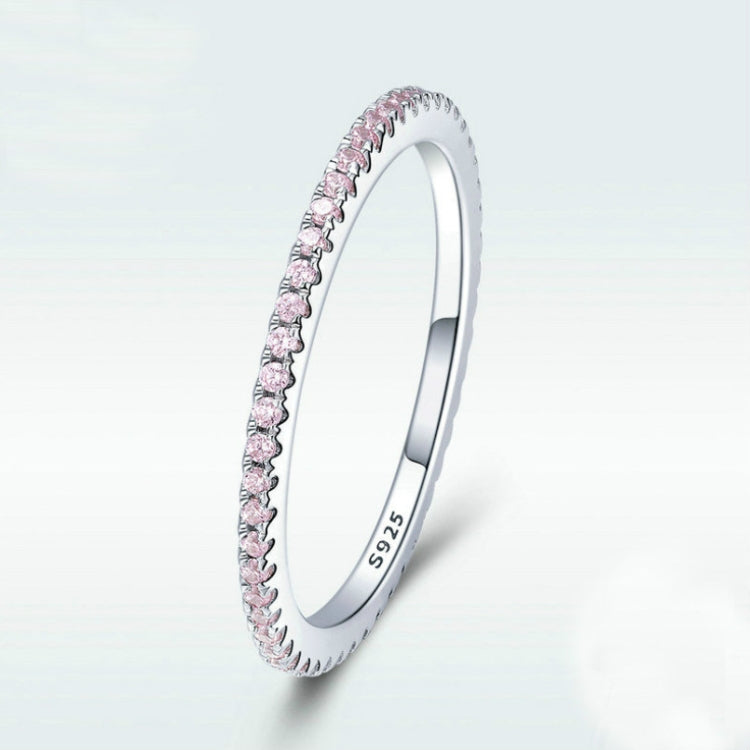 Sterling silver ring angled view with pink CZ stones along the band