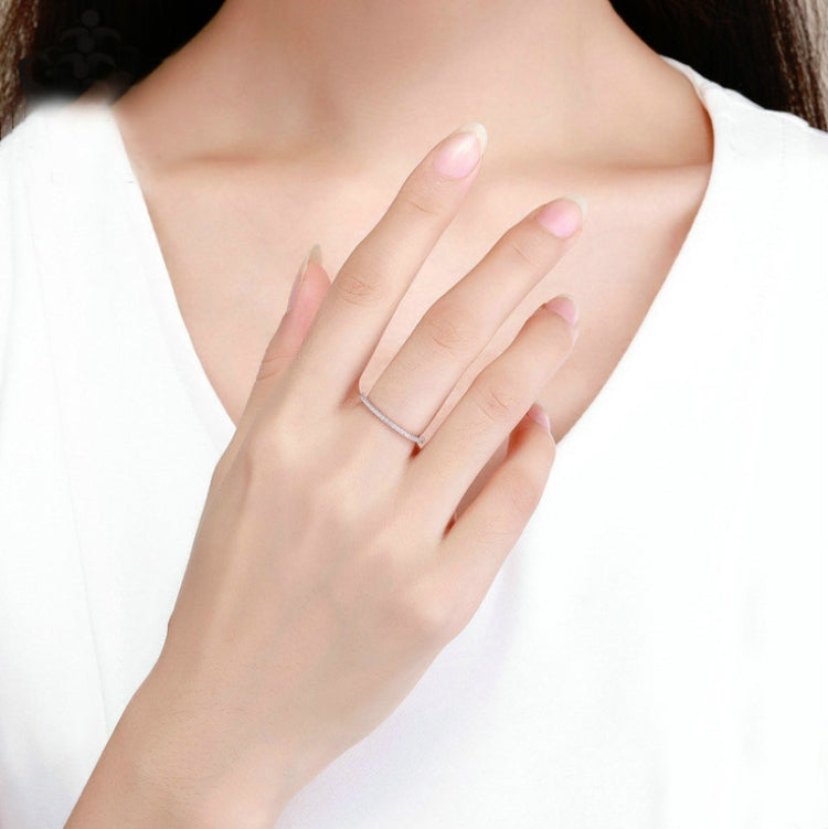 Sterling silver simple thin band ring on a woman's finger
