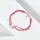 Red braided string bracelet with sterling silver star charm and silver clasp