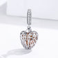 Sterling silver angel wing heart charm pendant shown from side, with rose-gold heart center