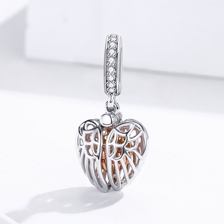Sterling silver angel wing heart charm pendant shown from side, with rose-gold heart center
