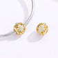 Two gold daisy charm beads with white flower centers