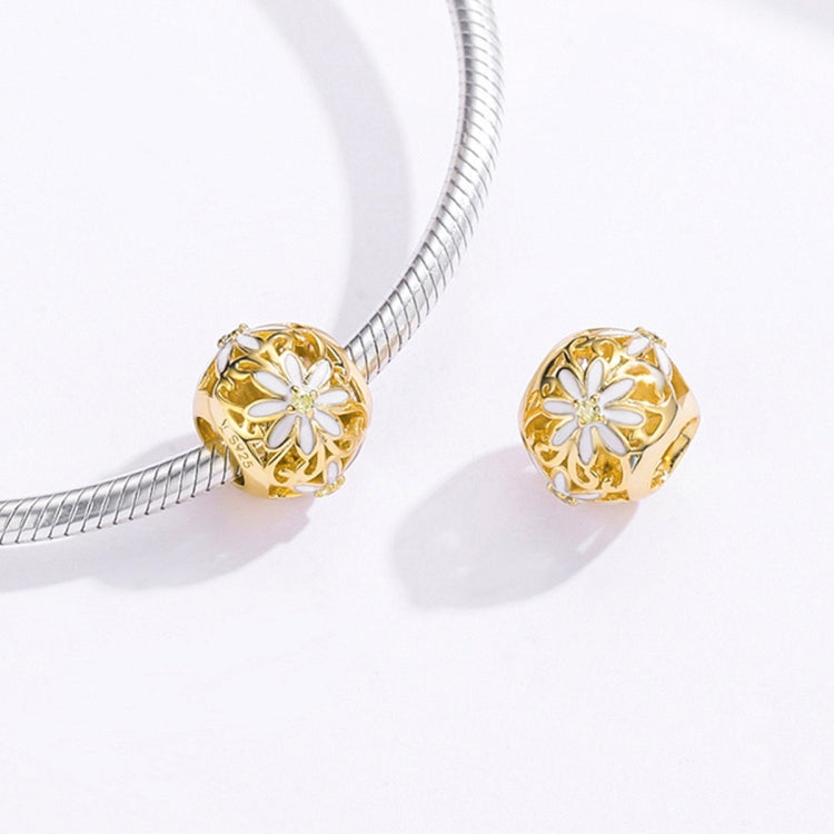 Two gold daisy charm beads with white flower centers
