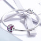 Round purple gemstone bead charm on silver snake bracelet with satin tie