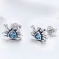 Oxidized silver crab stud earrings with blue heart-shaped gemstone and round clear stones