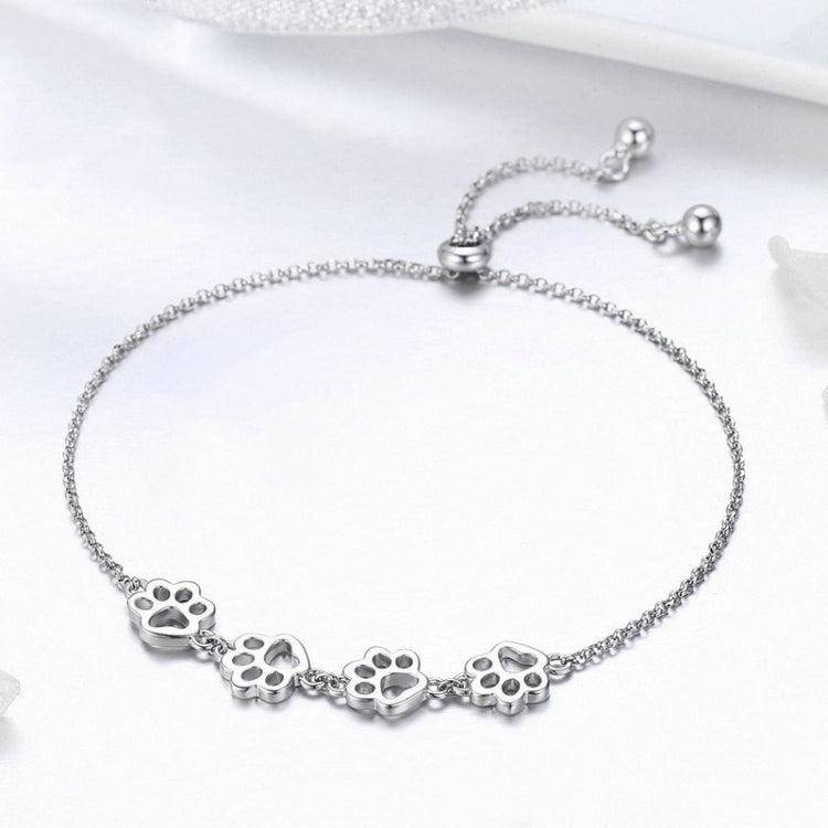 Paw print charm bracelet in sterling silver with five paw medallions on chain