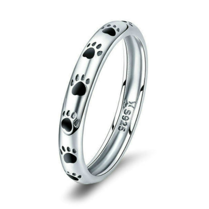 Sterling silver paw print ring with black enamel footprints, polished band