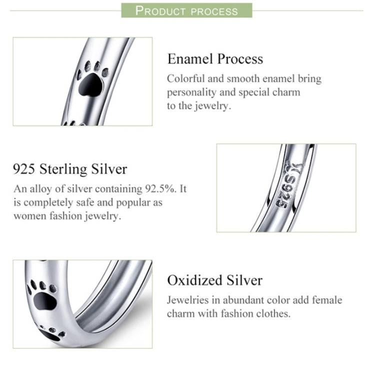 Sterling silver paw print ring with black enamel footprints, close-up side view