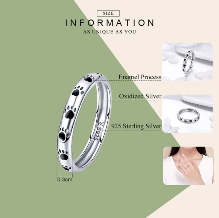 Sterling silver paw print ring with black enamel footprints, shown with size guide