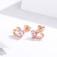 Pair of rose gold heart stud earrings with pink heart CZ stones
