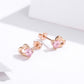 Rose gold heart stud earrings viewed from side with pink heart CZ stones