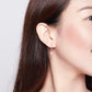 Model wearing sterling silver round zircon drop earrings with lever hooks