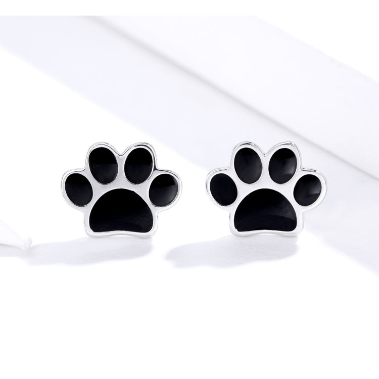 Sterling silver paw print stud earrings with black enamel paw pads and post backs